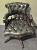 A 20th century Captain's chair, upholstered in green leather style fabric,
