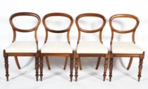 A set of four rosewood effect balloon back dining chairs, with drop in seats,