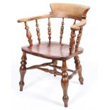 An elm smoker's bow chair, with turned spindles and solid seat,