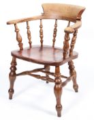 An elm smoker's bow chair, with turned spindles and solid seat,