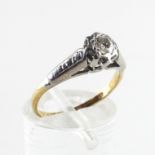 A yellow and white metal ring. Illusion set with a round brilliant cut diamond