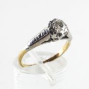 A yellow and white metal ring. Illusion set with a round brilliant cut diamond