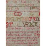 A 19th century needlework sampler, with the alphabet and a verse, framed,