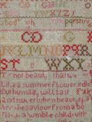A 19th century needlework sampler, with the alphabet and a verse, framed,
