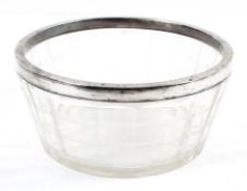 An Edwardian silver-mounted cut glass bowl, panel cut and cut with linear bands,