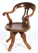 A Victorian walnut Captain's chair, with lyre-shaped splat, with scroll handles,