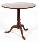 A George III mahogany tilt-top tea table, on column support on tripod legs, on pad feet,