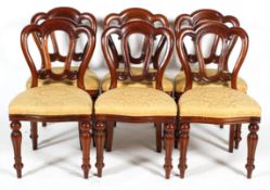 A set of six Victorian style mahogany balloon back dining chairs, with triple arched backs,