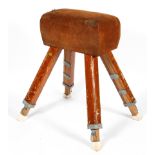 A vintage pommel horse by IE Bliss Ltd, in tan suede, on splayed legs, bearing yellow label,