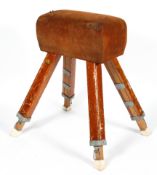 A vintage pommel horse by IE Bliss Ltd, in tan suede, on splayed legs, bearing yellow label,