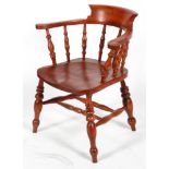 An elm smoker's bow armchair, with stained colouring,