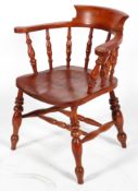 An elm smoker's bow armchair, with stained colouring,