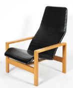 A 1970's vintage lounge chair, with ribbed black vinyl upholstery, on beech frame,