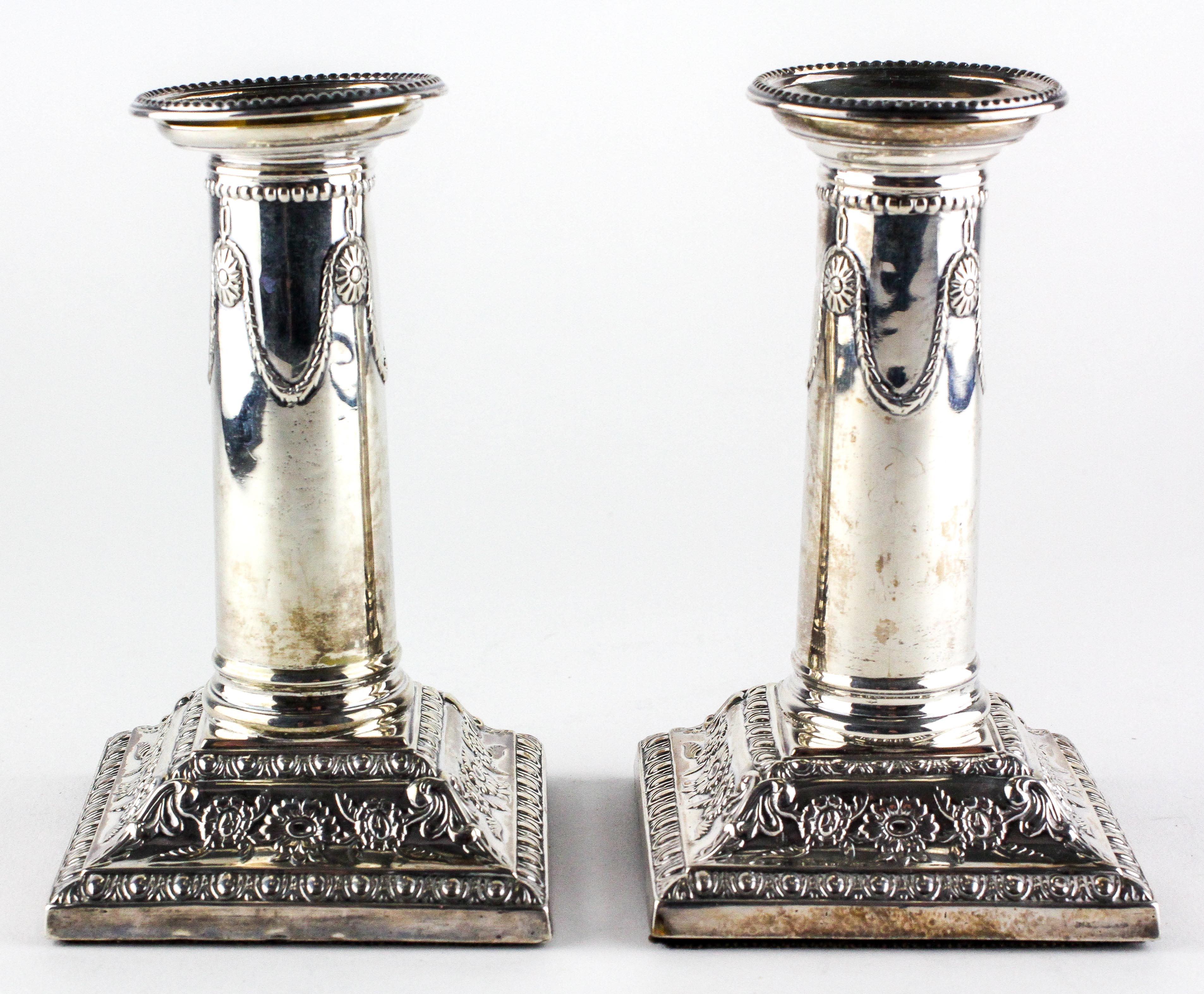 A pair of Edward VII silver candlesticks,