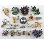 A collection of twenty one costume brooches of variable designs.