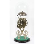 A fusee passing strike skeleton clock, under a glass dome, 20th century, with pendulum and key,