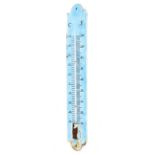 An enamelled tin wall thermometer, marked for centigrade and fahrenheit,