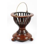 A Dutch mahogany kettle stand, late 19th/early 20th century, with brass swing handle,