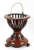 A Dutch mahogany kettle stand, late 19th/early 20th century, with brass swing handle,