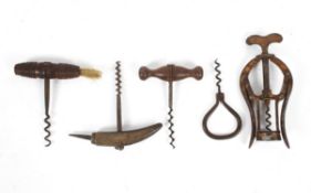 A collection of antique corkscrews, including three with turned wood handles,