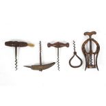 A collection of antique corkscrews, including three with turned wood handles,