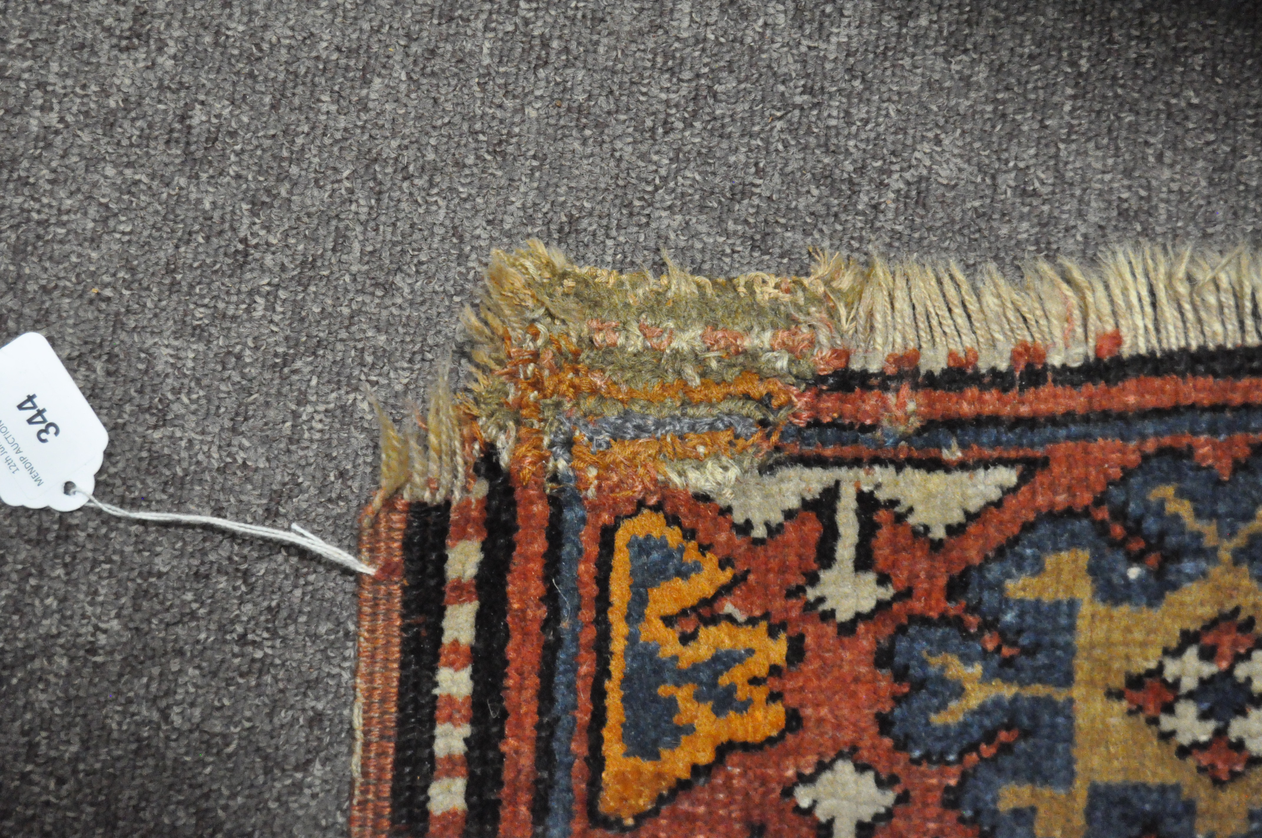 A 20th century Kazak style wool rug, woven with geometric lozenges on a blue ground with red border, - Image 4 of 13