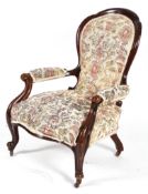 A Victorian spoon back armchair, with a walnut frame and tapestry upholstery,