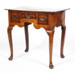A George II oak low boy, with canted cross banded top above three drawers with brass swing handles,
