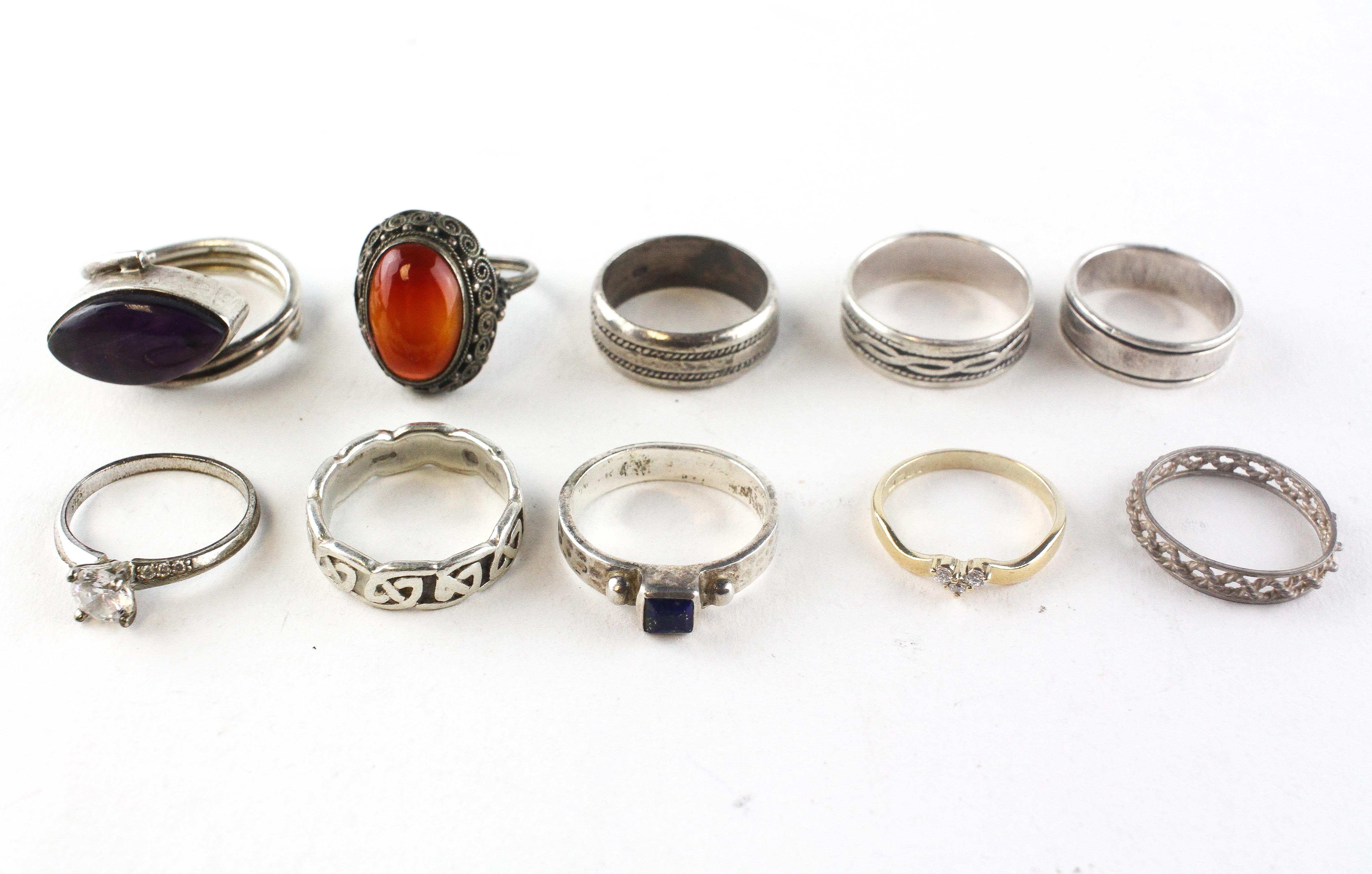 A collection of ten rings of variable designs. Most are marked or...