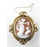 A yellow metal carved cameo brooch with mourning section to reverse having hair enclosed.