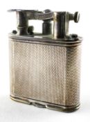 A vintage Dunhill lighter, adorned with engine turned decoration, pat no 288806,