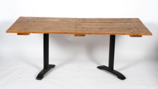 A table made from an oak door on metal legs,