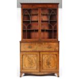 A George III mahogany secretaire bookcase, the glazed double doors with arched astragal,