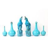 Two pairs of Burmantofts faience turquoise-glazed bottle-shaped vases and a pair of Chinese-style