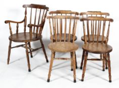 A set of five elm kitchen chairs with spindle back and circular seats, including a carver,