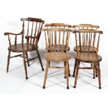 A set of five elm kitchen chairs with spindle back and circular seats, including a carver,