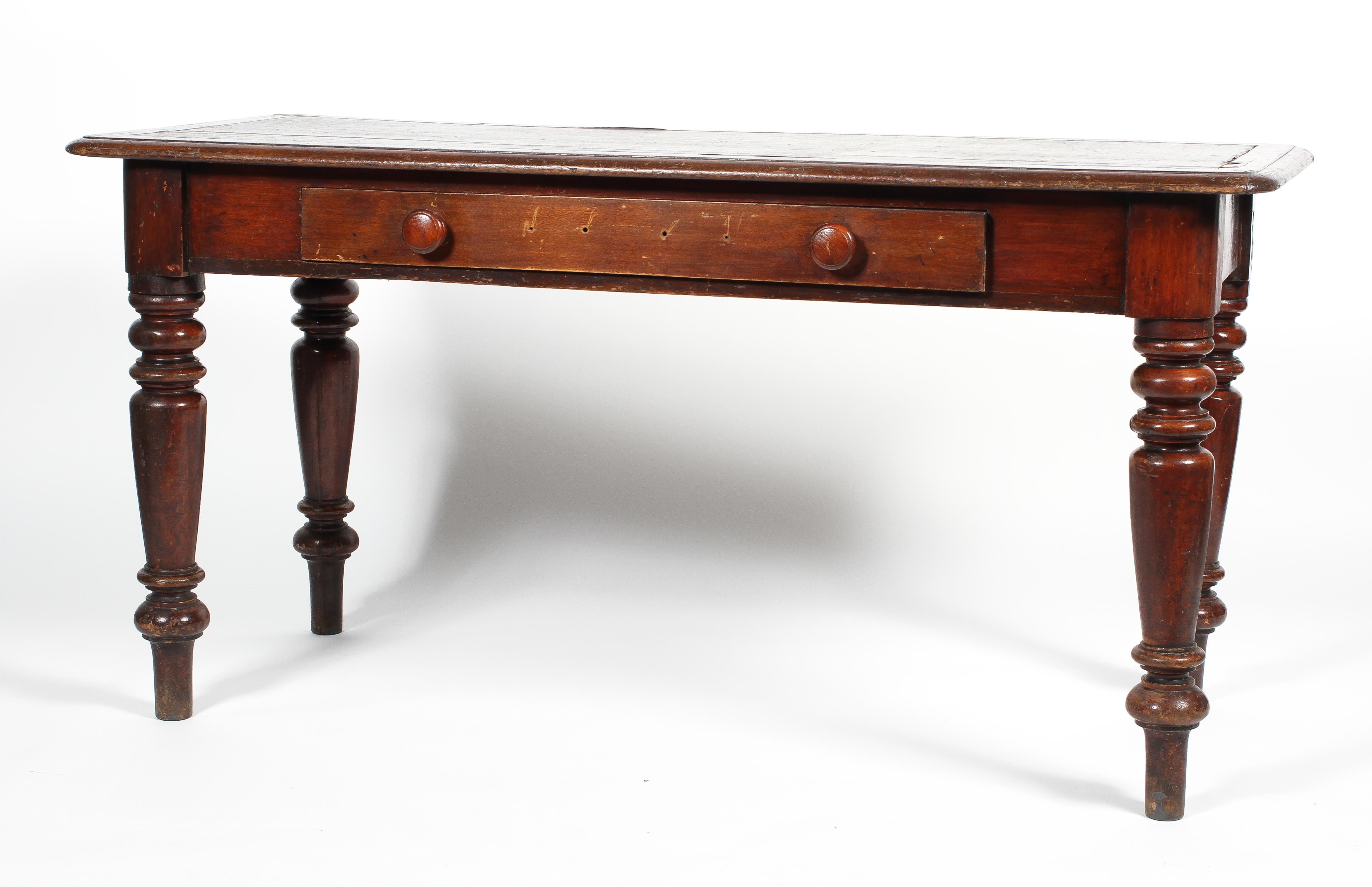 A Victorian mahogany desk on turned supports,