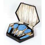 An Art Deco silver-mounted blue guilloche enamel dressing table set,