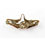 A yellow metal abstract bar brooch set with seed pearls. Hallmarked 9ct gold, Chester, 1906