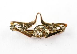 A yellow metal abstract bar brooch set with seed pearls. Hallmarked 9ct gold, Chester, 1906