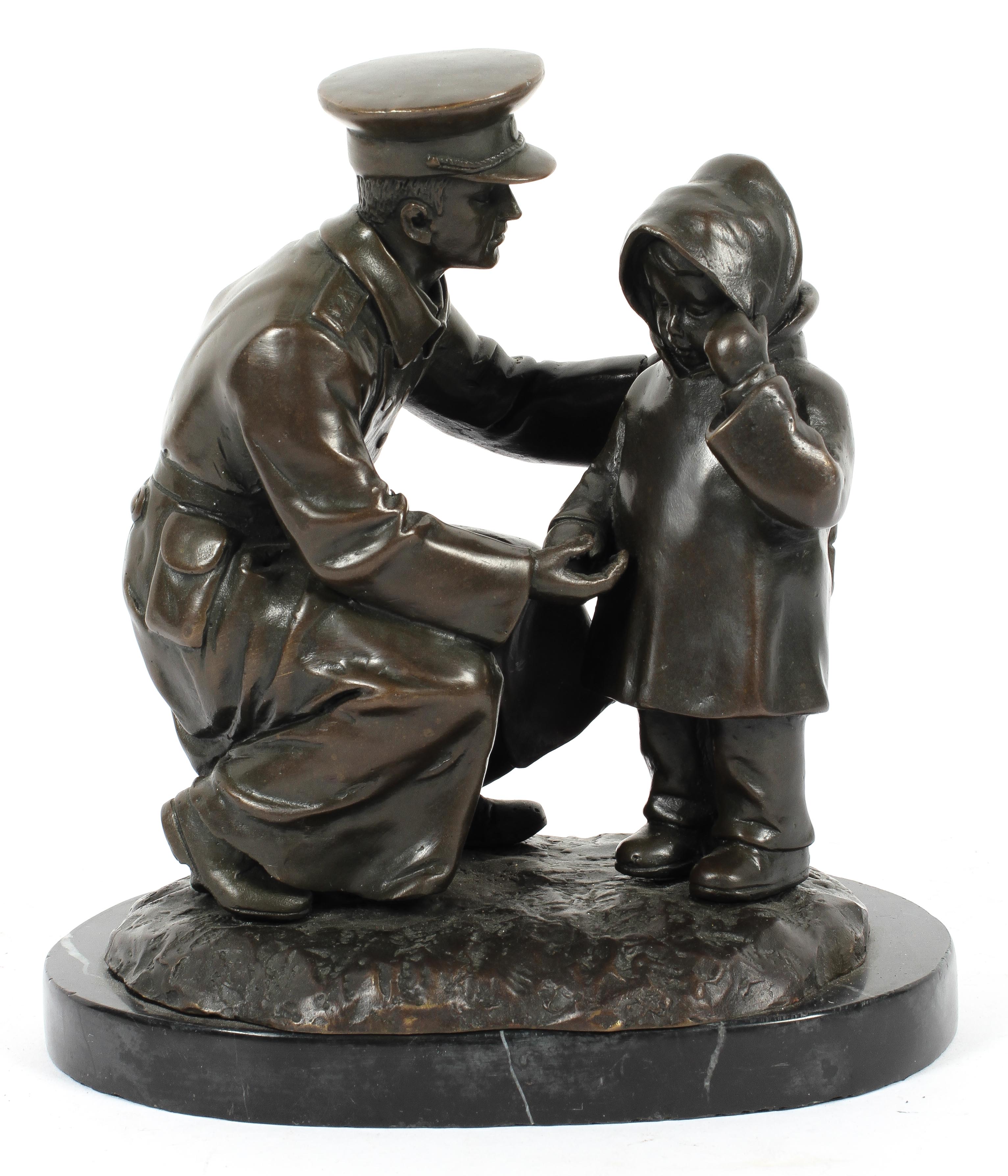 Bronze sculpture of an officer and child on a rocky mound and black marble base,