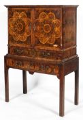 An oyster veneered cabinet on stand, 17th century style but later in date,