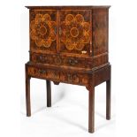 An oyster veneered cabinet on stand, 17th century style but later in date,