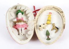 A bisque porcelain doll and four small painted wooden miniature figures,