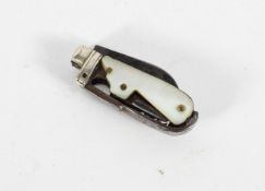 A miniature penknife, with a blade, corkscrew, pick and mother of pearl handle,