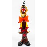A Venetian glass model of a clown, wearing a black and white conical hat,