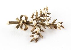 A yellow metal spray brooch set with 3.00mm cultured pearls. Hallmarked 9ct gold, Birmingham, 1962.