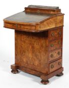A Victorian burr walnut davenport, inset with green leather writing slope, with gilt-metal gallery,