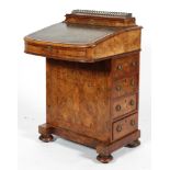 A Victorian burr walnut davenport, inset with green leather writing slope, with gilt-metal gallery,