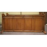 Two oak pew backs, early 20th century, each with carved scroll brackets,